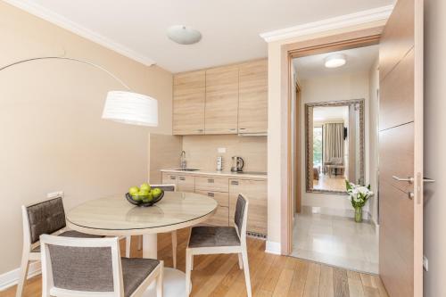 a kitchen with a table and chairs and a dining room at Apartments Grifone Lux in Herceg-Novi