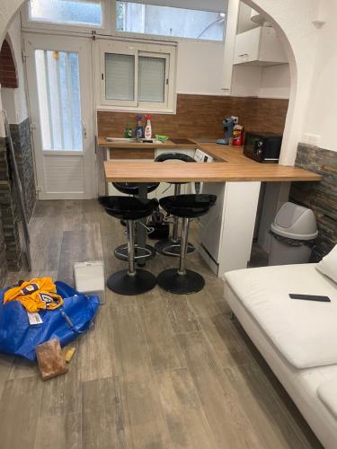 a kitchen with a counter and stools in a room at Small renovated cozy spot in Palavas-les-Flots