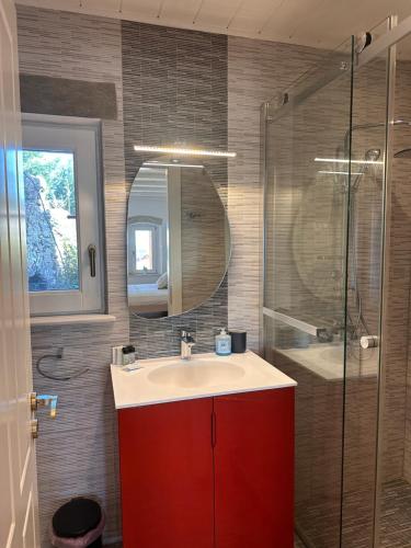 a bathroom with a red sink and a shower at Kytheros in Potamós