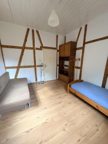 a bedroom with two beds and a wooden floor at Naturblick in Neresheim