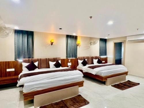 a bedroom with two beds in a room at Hotel Sunshine Apartment in Bathinda