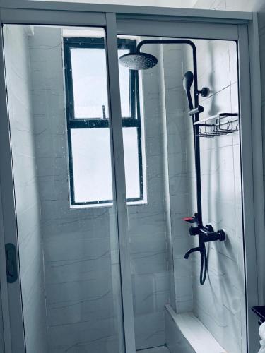 a shower in a bathroom with a glass door at Apartment in Kitusuri in Nairobi