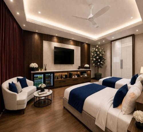 a bedroom with two beds and a flat screen tv at Hotel La Casa Near Delhi Airport in New Delhi