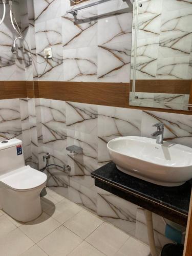 a bathroom with a sink and a toilet at Nanda niwas 2 in McLeod Ganj