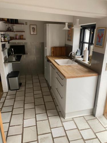 a kitchen with a sink and a counter top at Byhus Bogense in Bogense
