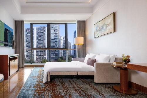 a hotel room with a bed and a large window at 杭州钱江新城黄龙璀怡酒店 凯悦尚选 in Hangzhou