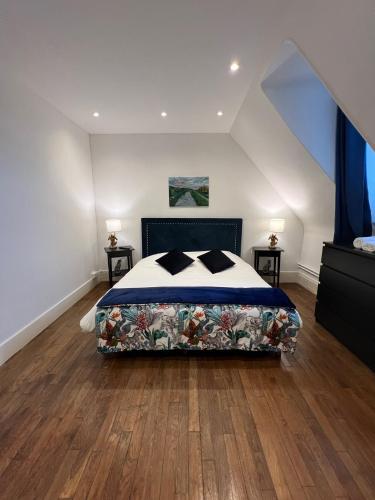 a bedroom with a bed and two night stands at Le Prieuré de Buffon in Buffon