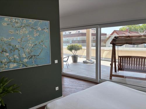 a room with a painting on the wall next to a window at Ostwall Terrassen Apartment in Bocholt