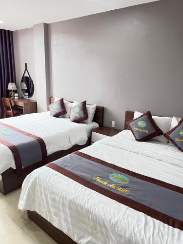 a hotel room with two beds in a room at Thach An Hotel in Ðông Khê