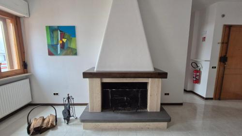 a fireplace in a room with a painting on the wall at Attico 14 in Castel di Sangro