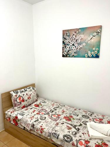 a bedroom with a bed and a painting on the wall at Centrino in Burgas