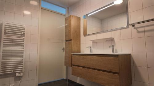 a bathroom with a sink and a mirror at Residentie De Zeester | De Wulk in Scherpenisse