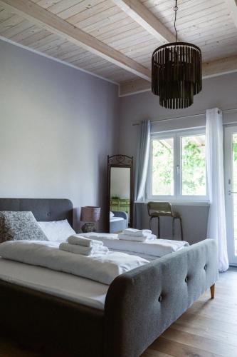 a bedroom with a large bed and a chandelier at Kirchstett in Sankt Wolfgang