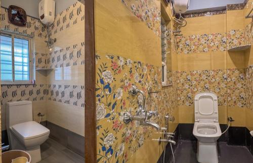 a bathroom with a toilet and a sink at The Botanika Suites in New Town