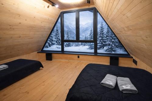 a room with a large window in a cabin at Top Hill Vista in Sekulić 