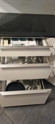 a white cabinet with some dishes in it at Sofia Apartment - Aare Jungfrau AG in Wilderswil
