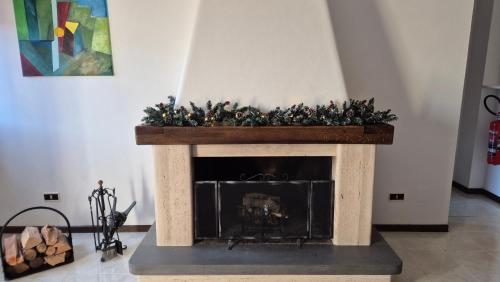 a fireplace with a christmasreath on top of it at Attico 14 in Castel di Sangro