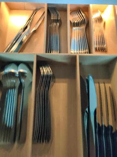 two shelves filled with utensils in a refrigerator at Bodmi on the top Apartment - Aare Jungfrau AG in Grindelwald