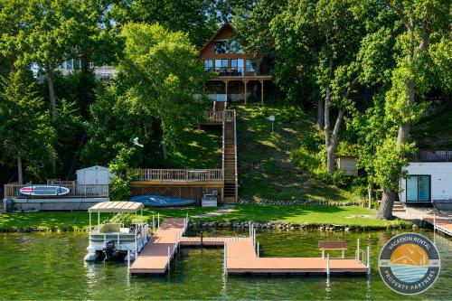 a house on the water with a dock and a boat at 405 Waldeck Dr in Twin Lakes