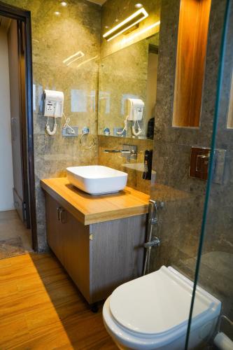 a bathroom with a sink and a toilet at SOLARAA iNN in Anjuna