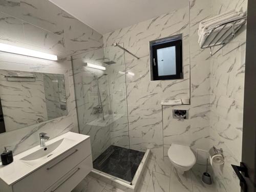 a bathroom with a sink and a toilet and a television at Vila SEA VIBES in Eforie Sud