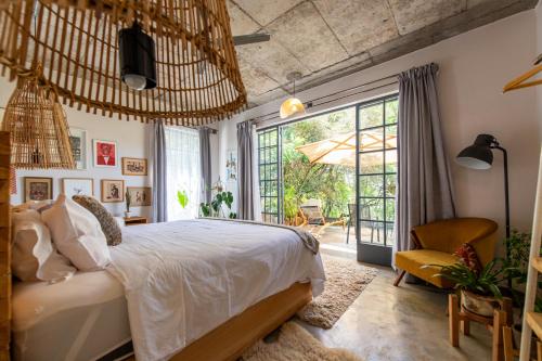 a bedroom with a bed and a large window at Afrika House in Nairobi