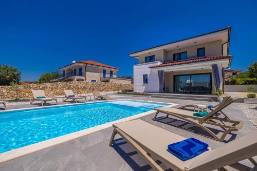 a villa with a swimming pool and a house at Villa ADRIA MOMENTS with private pool in Pinezici