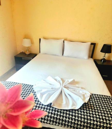 a bedroom with a bed with a dress on it at Complex MONACO HOTEL & CASINO in Svilengrad