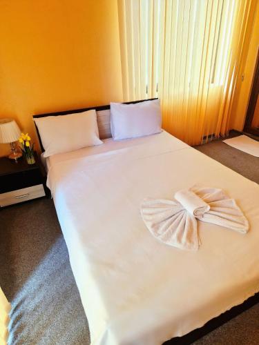 a large white bed with a bow on it at Complex MONACO HOTEL & CASINO in Svilengrad
