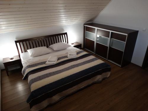 a bedroom with a large bed with two pillows at Holiday House Sabala 1 in Stará Lesná