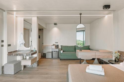 a living room with a couch and a desk at MAHA Her City Living by Semavί in Heraklio