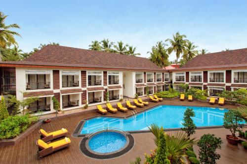 an image of the courtyard of a hotel with a swimming pool at Sobit Sarovar Portico in Palolem
