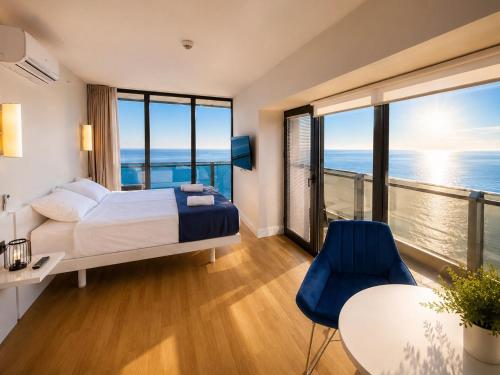 a bedroom with a bed and a view of the ocean at Seaside Studio at Orbi City in Batumi