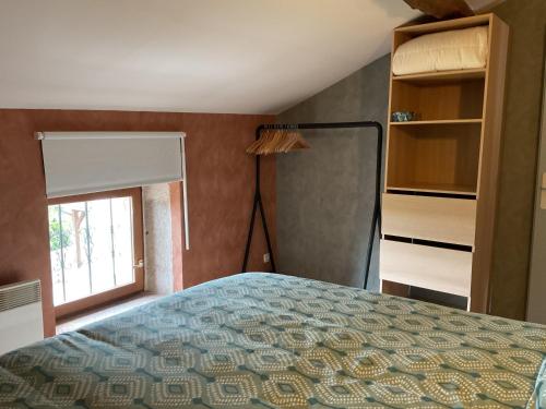 a bedroom with a bed and a window at Parenthèse clunysoise in Cluny