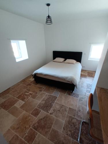 a bedroom with a bed and a tiled floor at mahuet florent in Bissy-sous-Uxelles