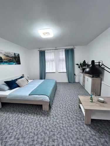 a bedroom with a bed and a table in it at Apartmán Líšný - U Jizery in Líšný