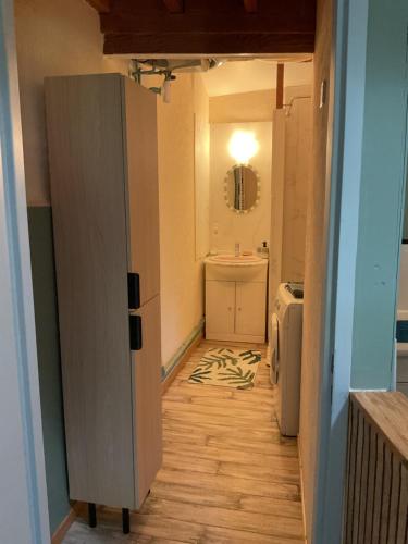 a bathroom with a toilet and a sink and a mirror at Parenthèse clunysoise in Cluny