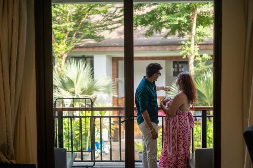 a man and a woman standing in front of a door at Sobit Sarovar Portico in Palolem