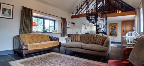 a living room with two chairs and a couch at Stable Lodge in Berwick-Upon-Tweed