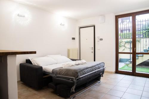 a bedroom with a bed and a large window at Humanitas - Leo Brothers - Leopardi 1 in Basiglio