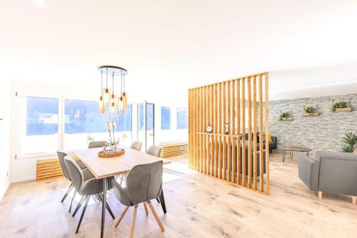 a dining room with a table and chairs at Alpin Chic - Aare Jungfrau AG in Grindelwald