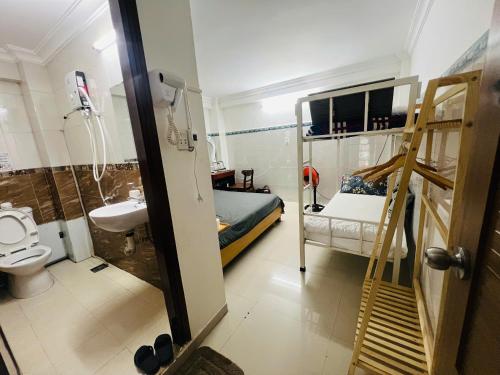 a bathroom with a bunk bed and a toilet and a sink at Khang Homestay in Danang