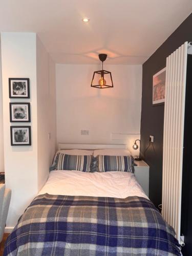 a bedroom with a bed with two striped pillows at Hesketh Hideaway 1 in Marshside