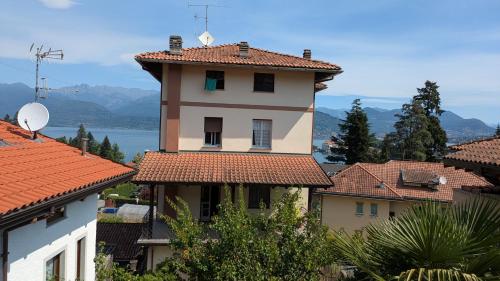 a building with red tile roofs in a town at Casa Nicolò Vista Lago in Stresa
