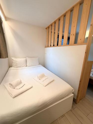 a bedroom with a bed with two towels on it at Hotel Le Chamonix in Chamonix