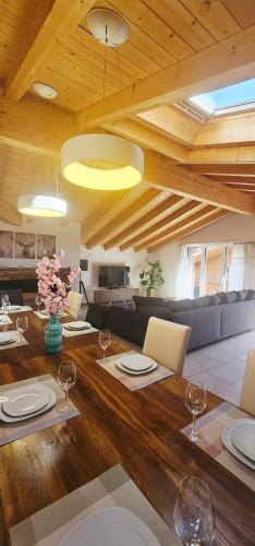 a living room with a wooden table with wine glasses at Jungfrau Penthouse - Aare Jungfrau AG in Wilderswil