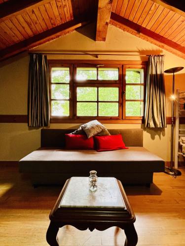 a bed in a room with a window and a table at Sallobante Aterpetxea - Casa in Mechicas