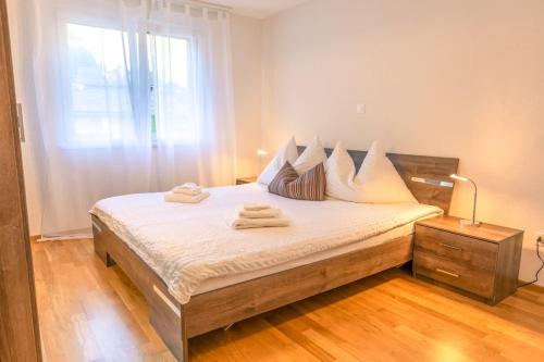 a bedroom with a bed with towels on it at Schilthorn Apartment - Aare Jungfrau AG in Wilderswil