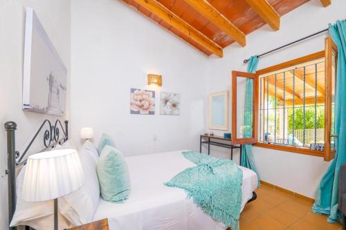 a bedroom with a bed and a window at Can Gallu - Adults Only. in Moscari