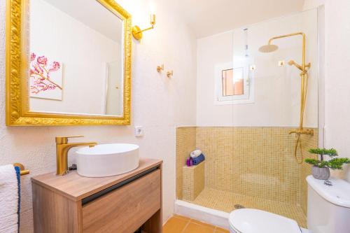 a bathroom with a sink and a mirror and a shower at Can Gallu - Adults Only. in Moscari